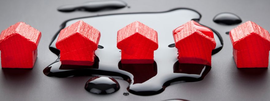 group of red mini wooden houses symbolizing a flooded area