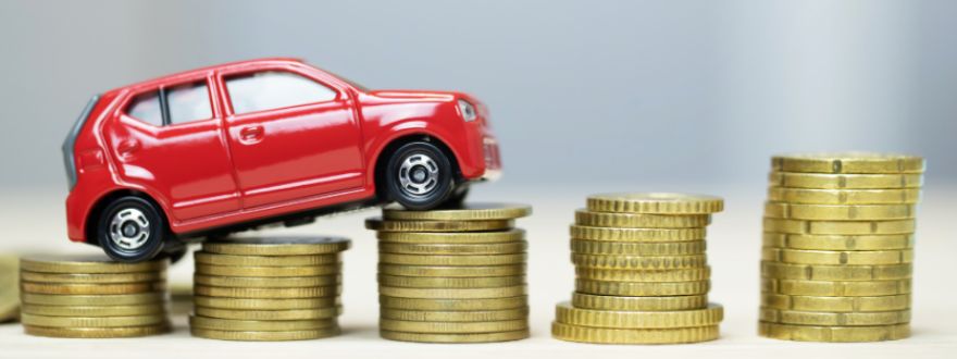 red car on top of a bunch of coins