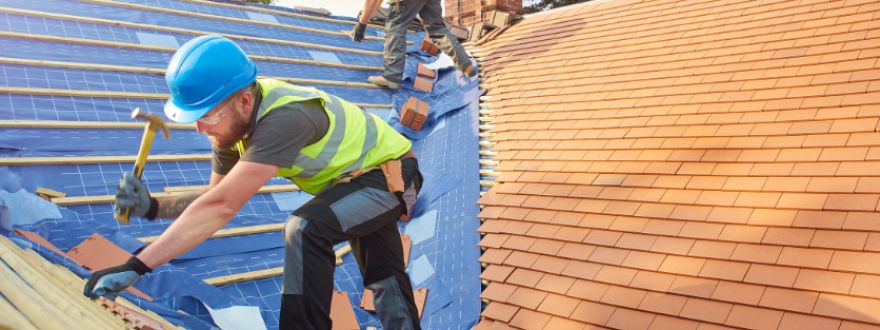 A crew fixing the roof of a Florida home damaged by a hurricane.