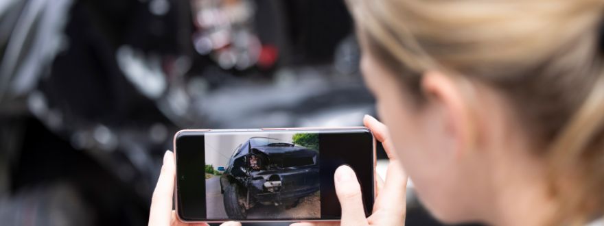 Florida driver taking photos of car after minor accident to file insurance claim