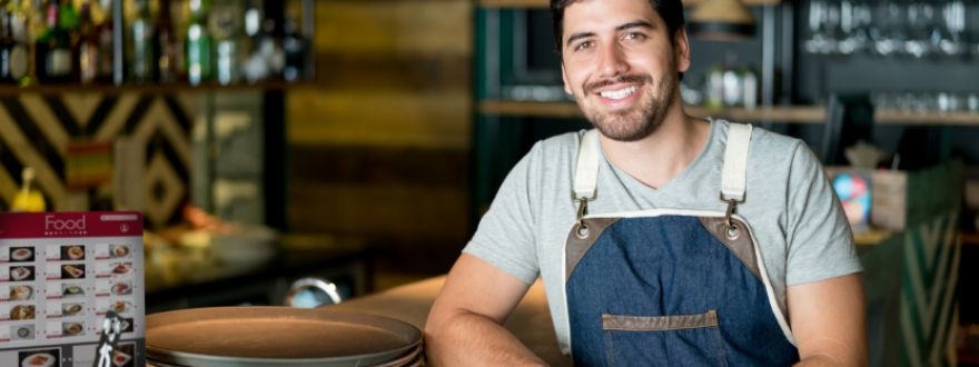 business owner smiling after savings from a business insurance policy from American US Insurance