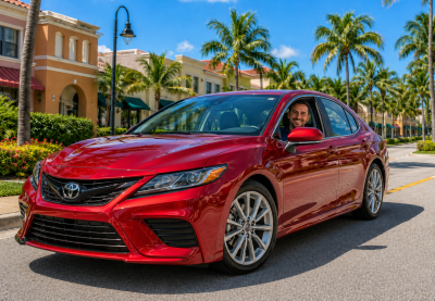 young woman smiling while driving a car insured by American US Insurance in Homestead Florida