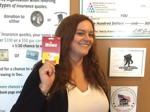 Kate Reber holding a gift card for winner Ms. Moneek Pines