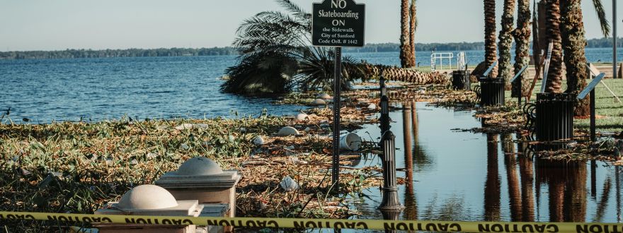 Picture of water near a Florida water way overtaking a sidewalk.