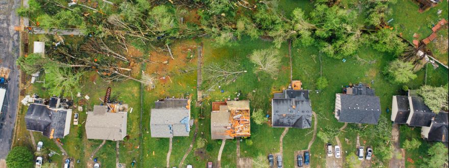 Dramatic aerial shot of tornado aftermath in a neighborhood.