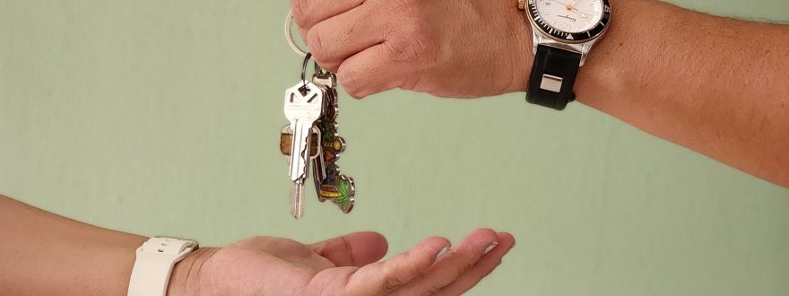 A picture of someone handing their keys to someone else.
