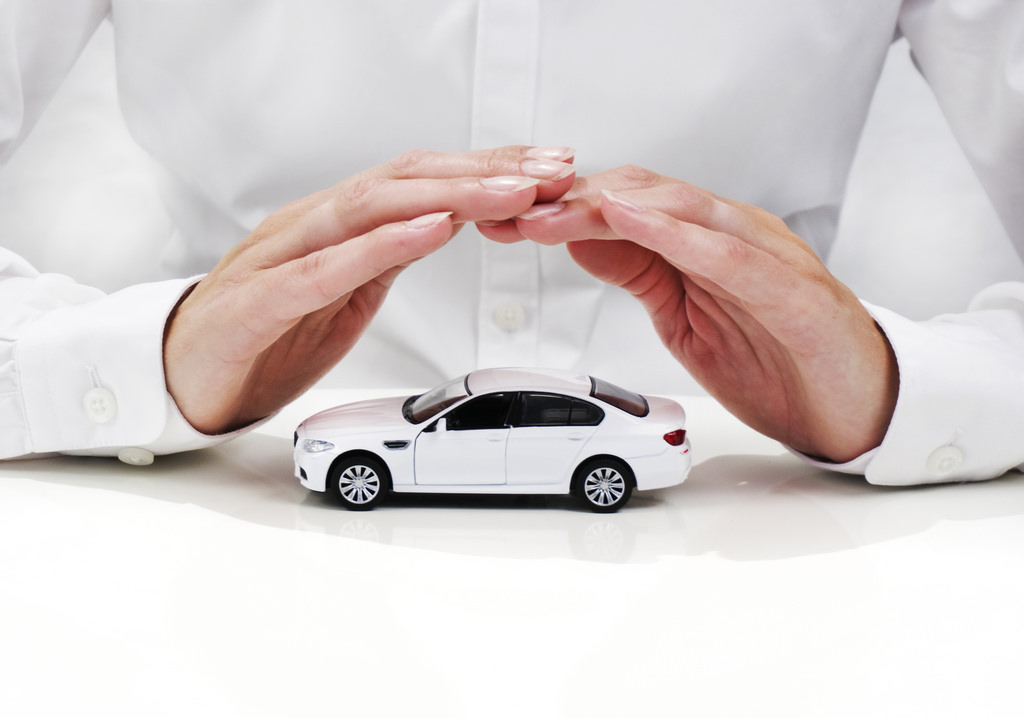 White car with hands above covering it.  The hands appear to be a female wearing a white shirt.