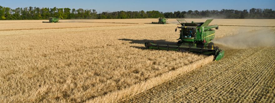 harvesting wheat with farmer equipment