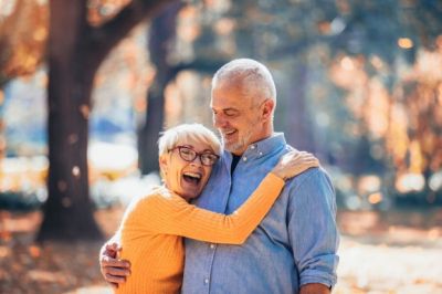 happy elderly couple hugging