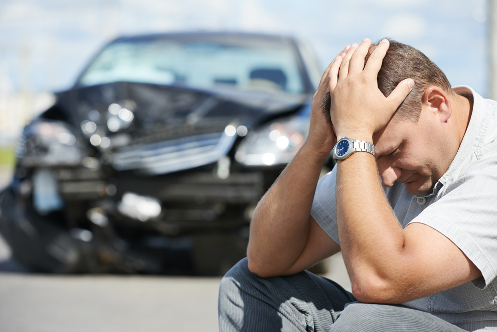 man worried due to car accident