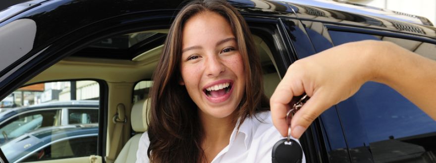 girl receiving keys to a new car