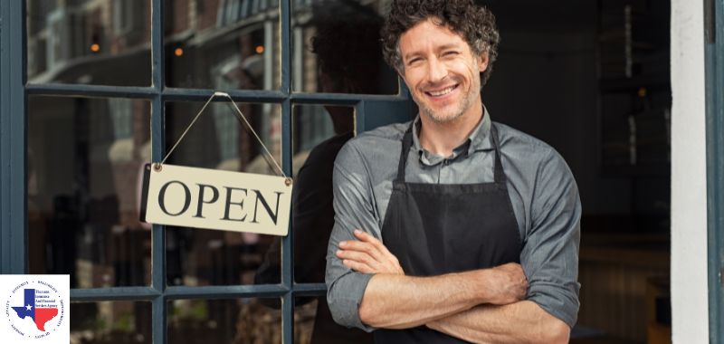 A restaurant owner standing in his entrance 