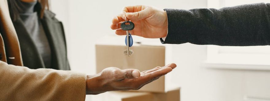 landlord handing house keys to the tenant