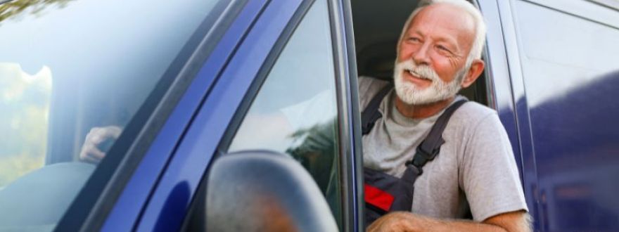 A driver in a blue van with commercial auto insurance