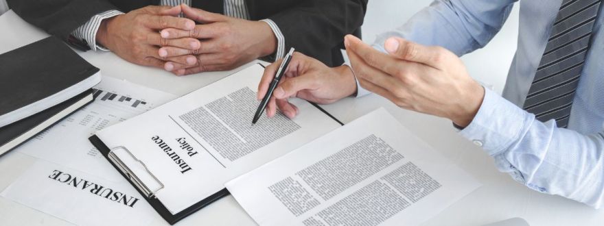 two persons are in a meeting discussing business insurance