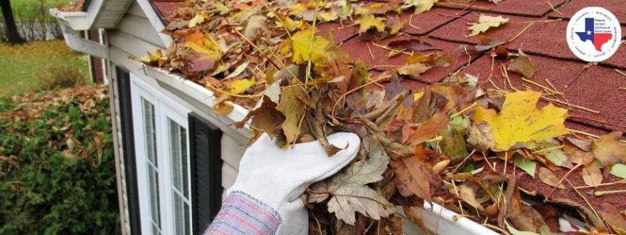 A person cleaning the gutters 