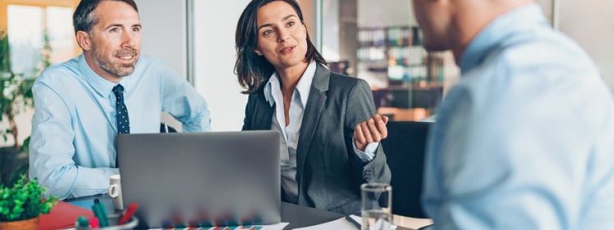 A Thumann Agency Risk Advisor discussing professional liability insurance coverage with a Dallas business client in a professional office meeting.