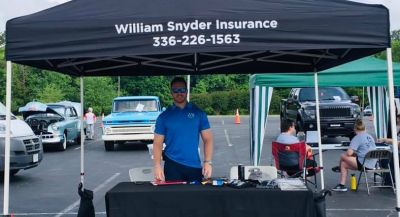 William Snyder at a booth advertising the William Snyder Insurance company